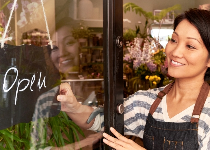 store owner flipping open sign