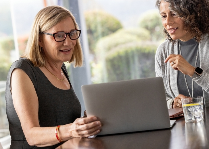 two ladies looking at laptop